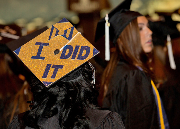 Graduate wearing a mortarboard that reads "I DID IT"